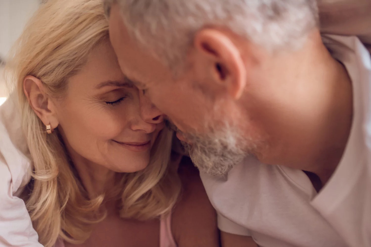 Mature American couple sharing a relaxed, affectionate moment at home